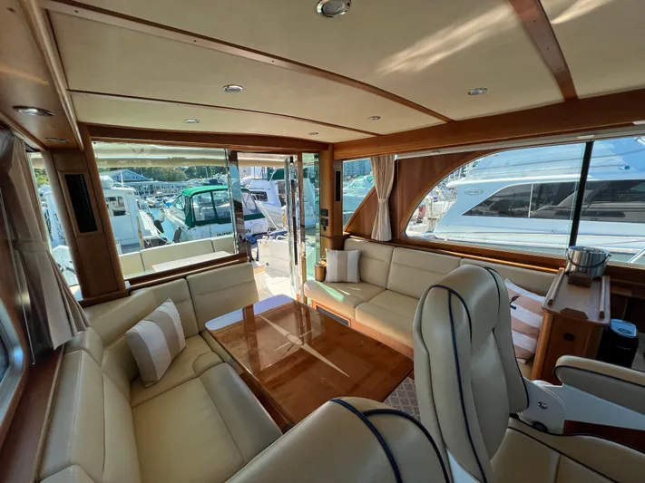 Family Affair Ix Yacht Photos Pics Luxurious interior of 2018 Sabre 45 Salon Express yacht with elegant seating and large windows.
