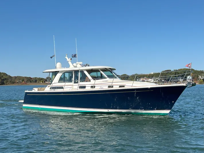Family Affair Ix Yacht Photos Pics 2018 Sabre 45 Salon Express yacht on calm water under clear blue sky.