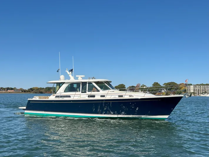 Family Affair Ix Yacht Photos Pics 2018 Sabre 45 Salon Express yacht on calm water under clear blue sky.
