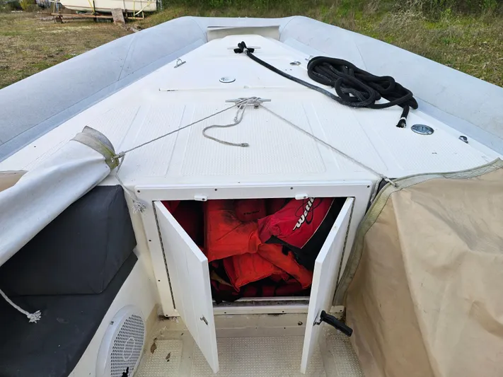 Ocean Spirit Yacht Photos Pics 1996 Eduardono RIB boat with open storage compartment containing life jackets.