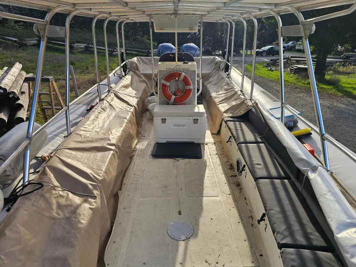 Ocean Spirit Yacht Photos Pics 1996 Eduardono RIB boat interior with canopy and seating, featuring a life preserver.