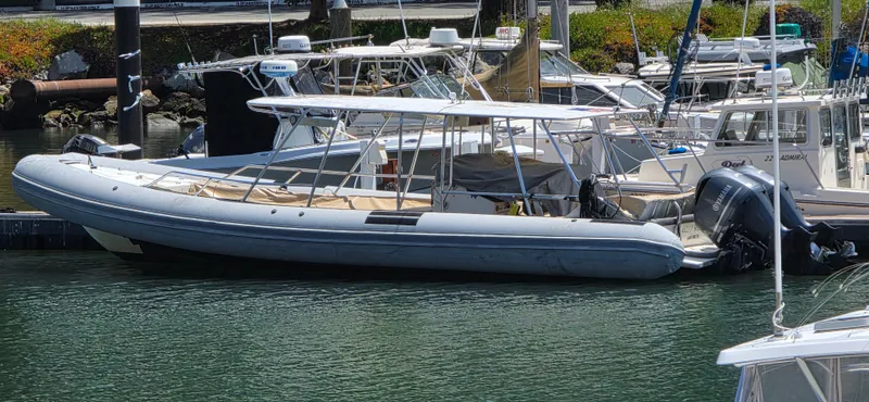 Ocean Spirit Yacht Photos Pics 1996 Eduardono RIB boat docked in a marina, surrounded by other vessels.