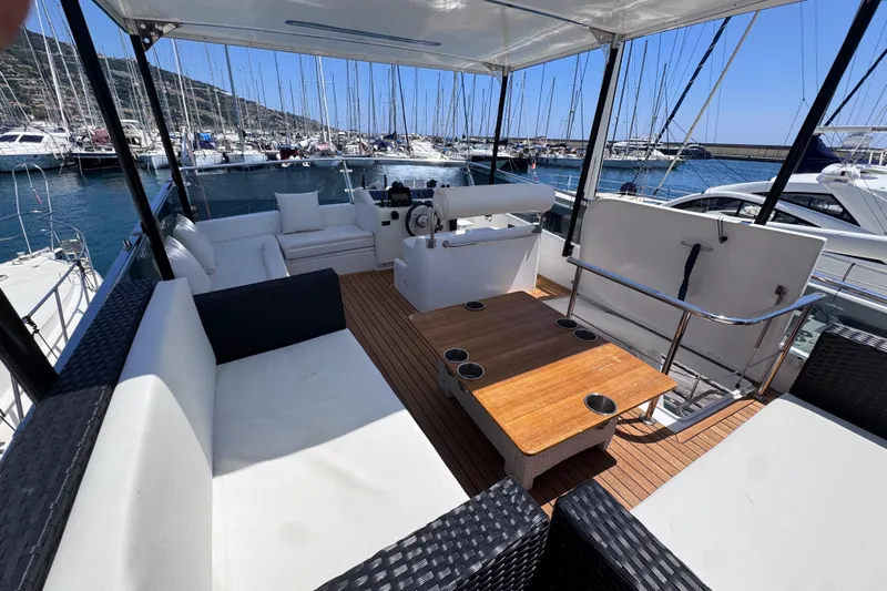  Yacht Photos Pics Luxurious 1998 Cantieri Lombardi 48 S yacht interior with elegant seating and wooden table.