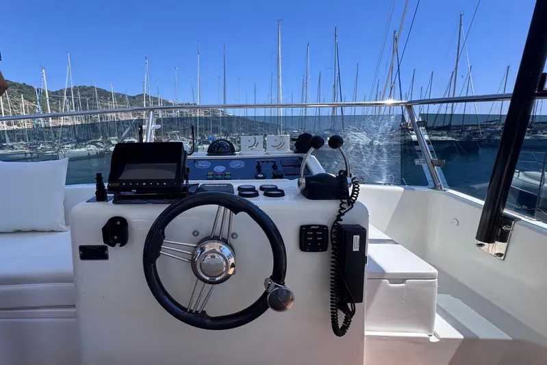  Yacht Photos Pics Helm of 1998 Cantieri Lombardi 48 S yacht with marina view.