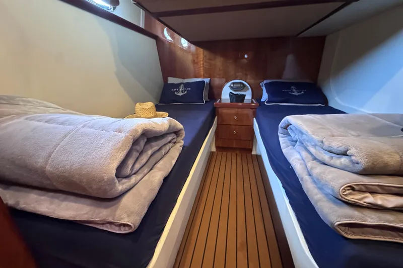  Yacht Photos Pics Luxurious cabin interior of 1998 Cantieri Lombardi 48 S yacht with twin beds.