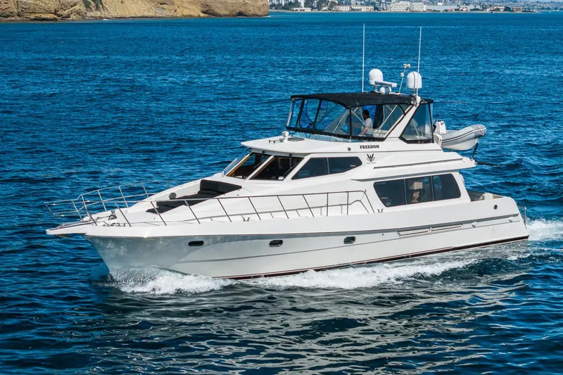 Freedom Yacht Photos Pics 2002 McKinna 57 Pilothouse yacht cruising on blue ocean waters.