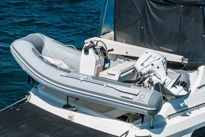 Freedom Yacht Photos Pics Inflatable Zodiac boat with Tohatsu motor on 2002 McKinna 57 Pilothouse yacht.