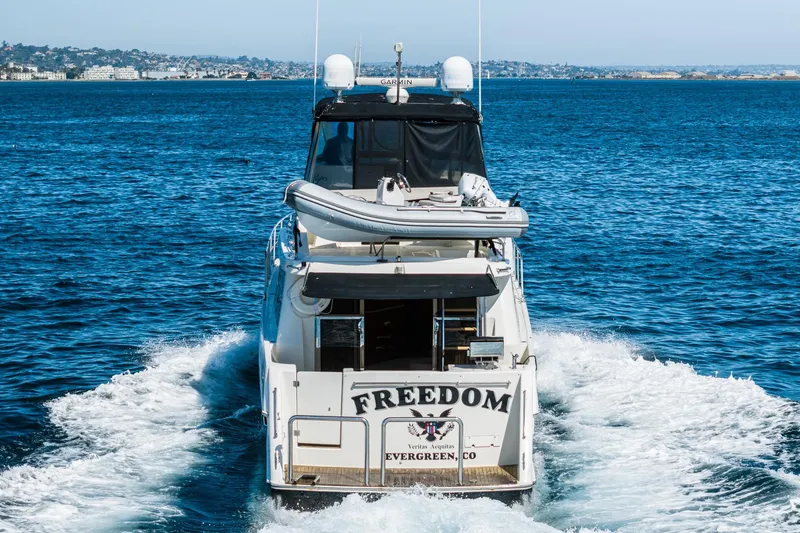 Freedom Yacht Photos Pics 2002 McKinna 57 Pilothouse yacht cruising on open water, rear view.