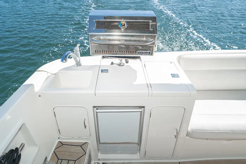 Freedom Yacht Photos Pics Outdoor kitchen on 2002 McKinna 57 Pilothouse yacht with grill and sink.