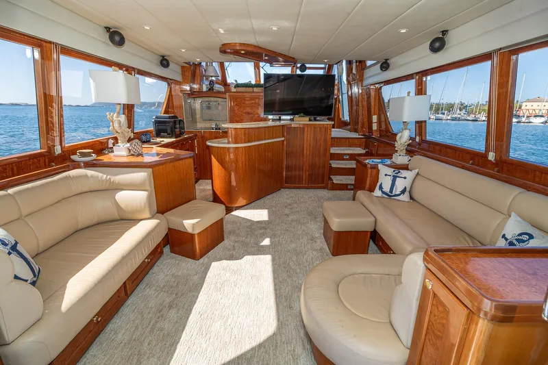 Freedom Yacht Photos Pics Luxurious interior of 2002 McKinna 57 Pilothouse yacht with elegant wood finishes and plush seating.