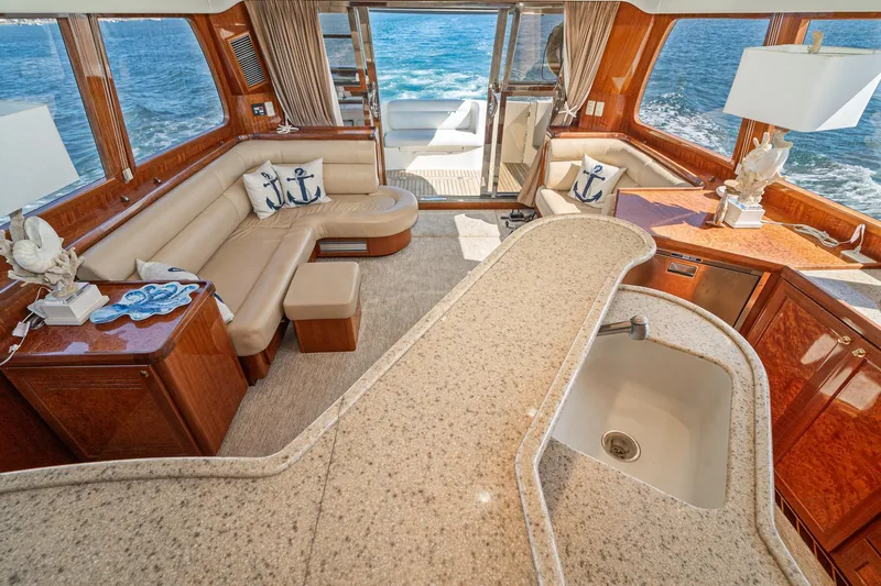 Freedom Yacht Photos Pics Luxurious interior of 2002 McKinna 57 Pilothouse yacht with elegant seating and ocean view.
