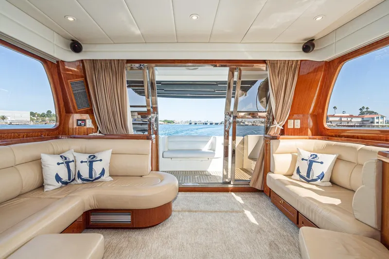 Freedom Yacht Photos Pics Luxurious interior of 2002 McKinna 57 Pilothouse yacht with elegant seating and nautical decor.