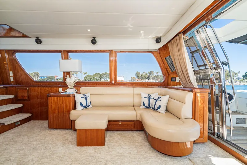 Freedom Yacht Photos Pics Luxurious interior of 2002 McKinna 57 Pilothouse yacht with plush seating and nautical decor.