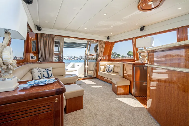 Freedom Yacht Photos Pics Luxurious interior of 2002 McKinna 57 Pilothouse yacht with elegant seating and nautical decor.