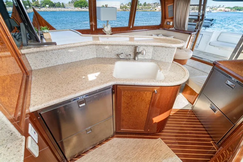 Freedom Yacht Photos Pics Luxurious 2002 McKinna 57 Pilothouse yacht interior with elegant kitchen and ocean view.