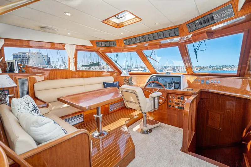 Freedom Yacht Photos Pics Luxurious interior of 2002 McKinna 57 Pilothouse yacht with elegant wood finish.