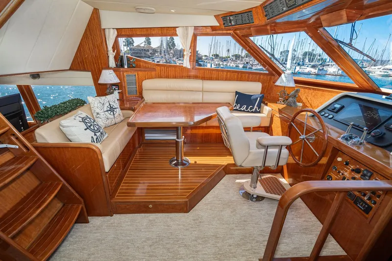 Freedom Yacht Photos Pics Luxurious 2002 McKinna 57 Pilothouse interior with plush seating and elegant wood finishes.