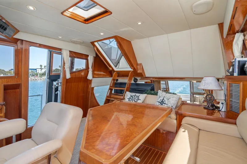 Freedom Yacht Photos Pics Luxurious interior of 2002 McKinna 57 Pilothouse yacht with elegant wood finishes.