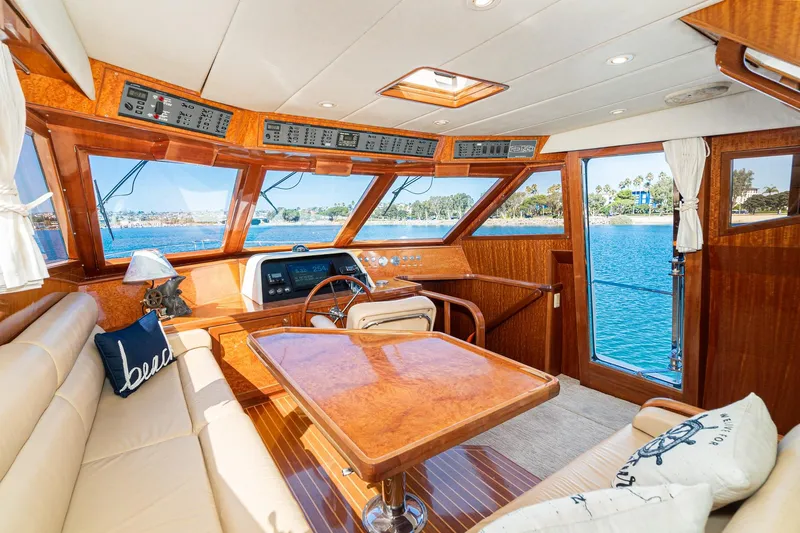 Freedom Yacht Photos Pics Luxurious 2002 McKinna 57 Pilothouse interior with wood finish and scenic water view.