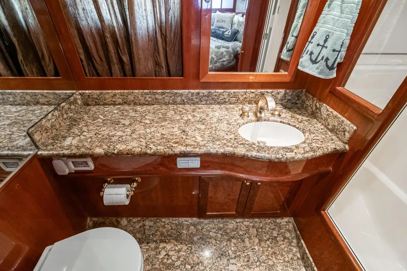 Freedom Yacht Photos Pics Luxurious bathroom in 2002 McKinna 57 Pilothouse yacht with granite countertop and elegant fixtures.
