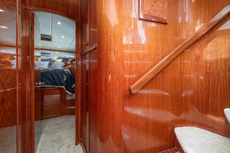 Freedom Yacht Photos Pics Luxurious interior of 2002 McKinna 57 Pilothouse yacht with polished wood and cozy bedroom.