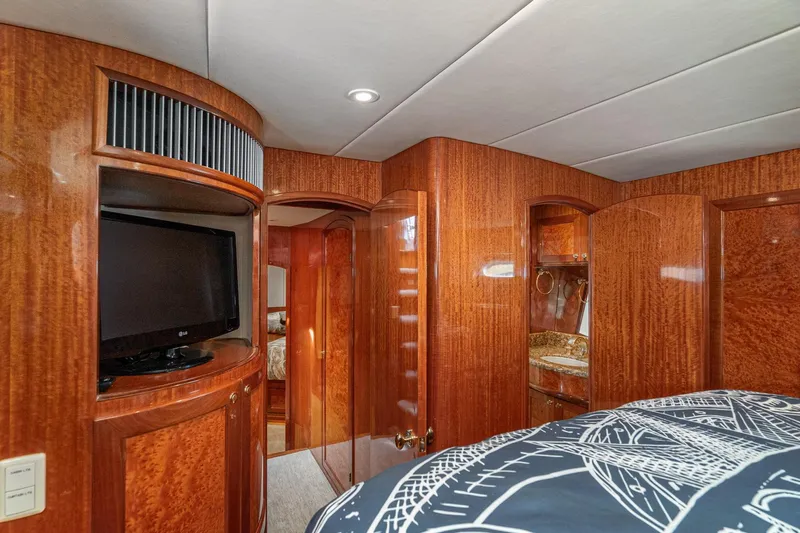 Freedom Yacht Photos Pics Luxurious interior of 2002 McKinna 57 Pilothouse yacht with wood paneling and TV.