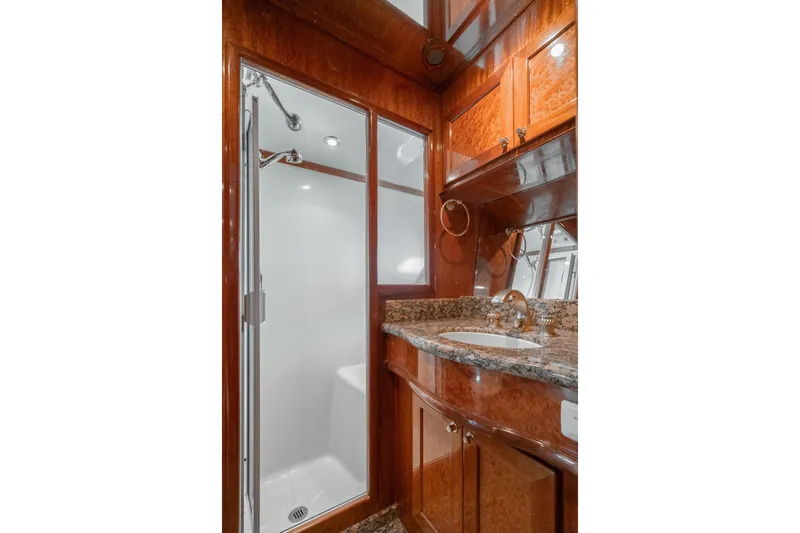 Freedom Yacht Photos Pics Luxurious bathroom in 2002 McKinna 57 Pilothouse yacht with granite countertop and enclosed shower.