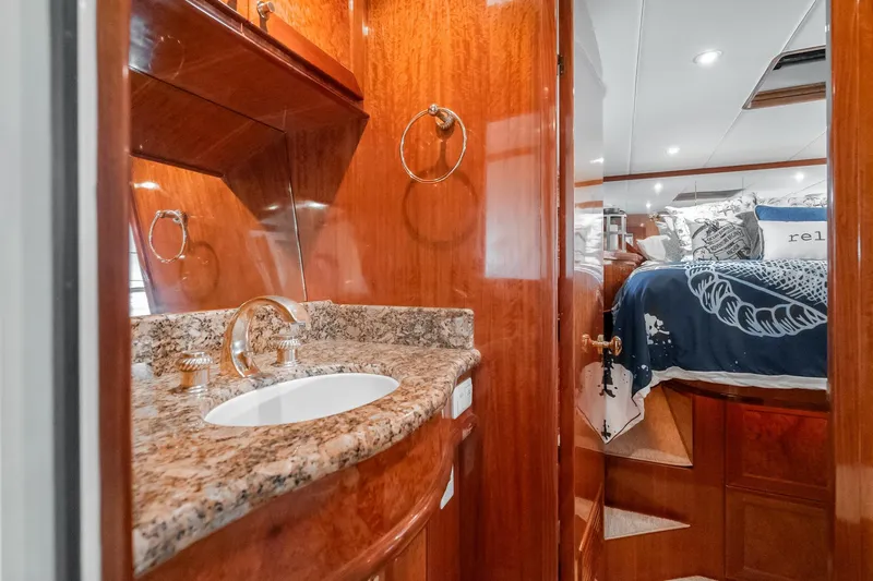 Freedom Yacht Photos Pics Luxurious 2002 McKinna 57 Pilothouse interior with elegant wood finish and granite sink.