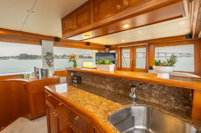 Freedom Yacht Photos Pics Luxurious 2005 Offshore Yachts Pilothouse interior with elegant wood finishes and granite countertops.