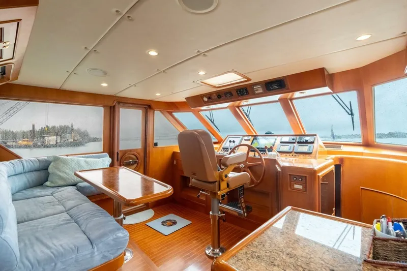 Freedom Yacht Photos Pics Luxurious 2005 Offshore Yachts Pilothouse interior with helm, seating, and panoramic windows.
