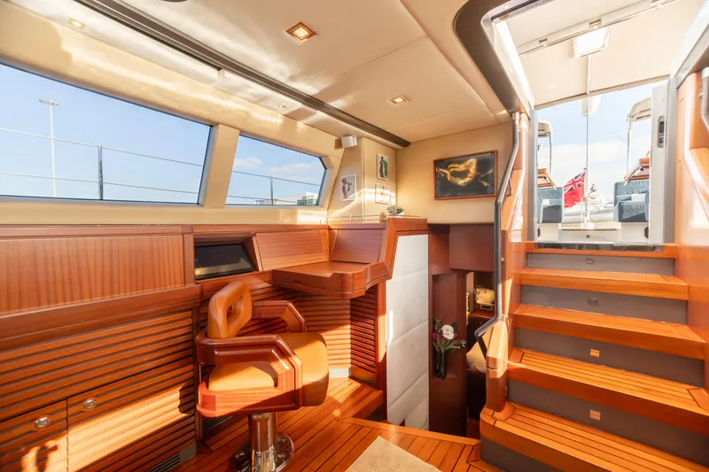 Assai Yacht Photos Pics Luxurious interior of 2011 Alia Yachts Warwick 82 LK with wooden finishes and staircase.