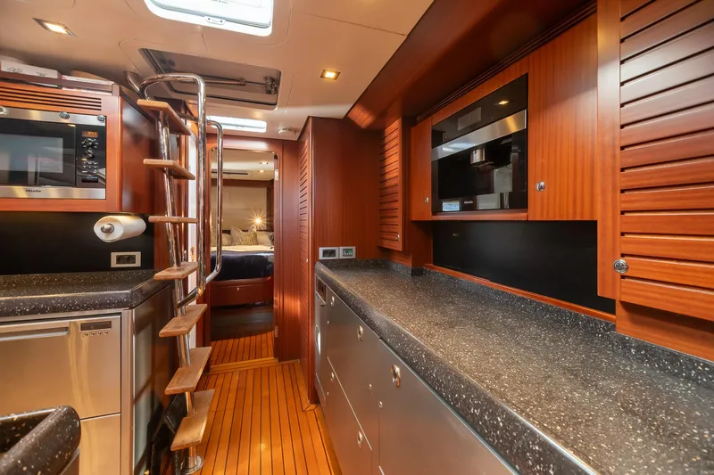 Assai Yacht Photos Pics Luxurious kitchen interior of 2011 Alia Yachts Warwick 82 LK with modern appliances and wooden finishes.