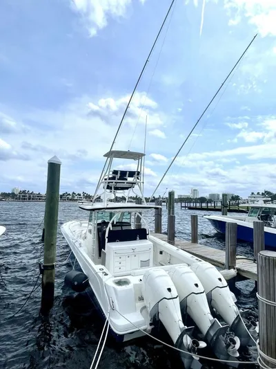 Reel Time Yacht Photos Pics 2013 Boston Whaler 370 Outrage docked with triple outboard engines.