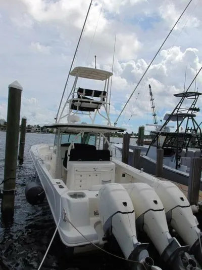 Reel Time Yacht Photos Pics 2013 Boston Whaler 370 Outrage docked with triple outboard engines.