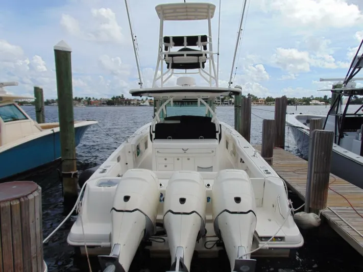 Reel Time Yacht Photos Pics 2013 Boston Whaler 370 Outrage docked, featuring triple outboard engines.