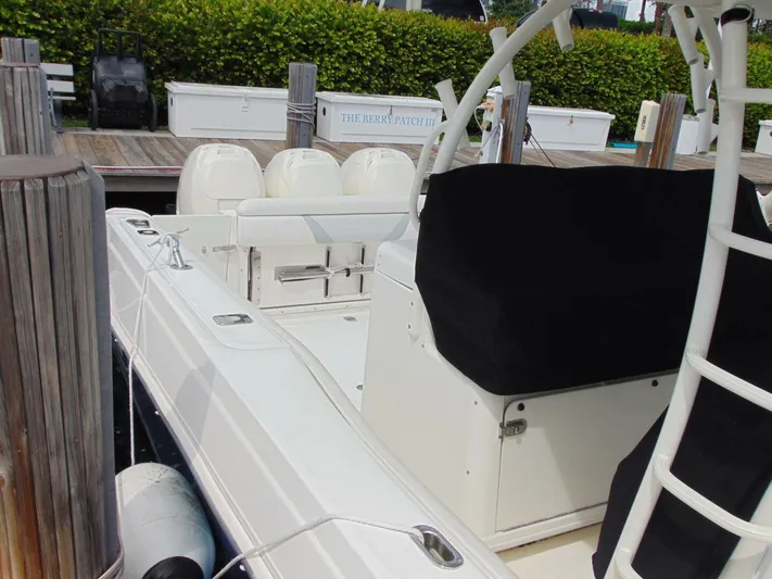 Reel Time Yacht Photos Pics 2013 Boston Whaler 370 Outrage docked, featuring sleek design and spacious seating.