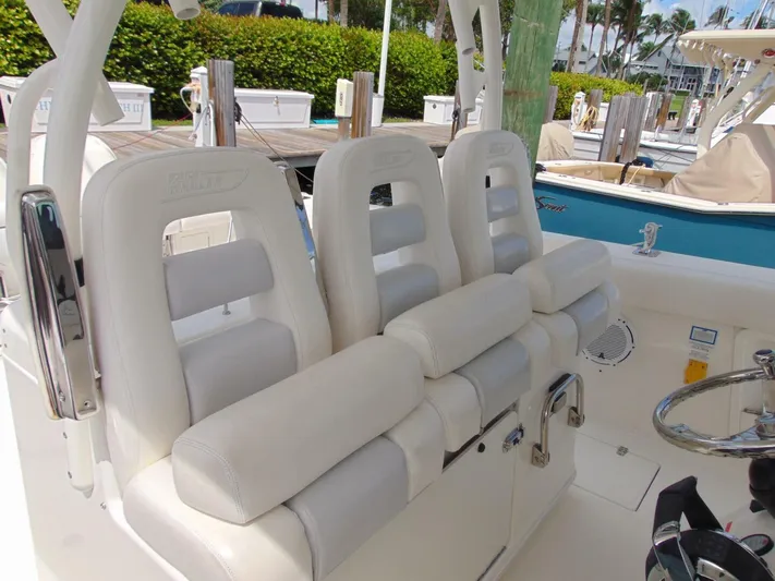Reel Time Yacht Photos Pics 2013 Boston Whaler 370 Outrage boat seats, white leather, docked marina background.