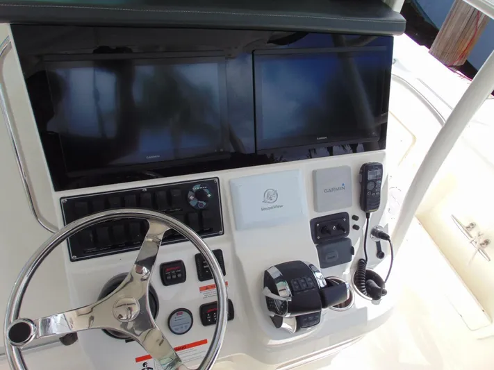 Reel Time Yacht Photos Pics 2013 Boston Whaler 370 Outrage helm with dual screens and navigation controls.
