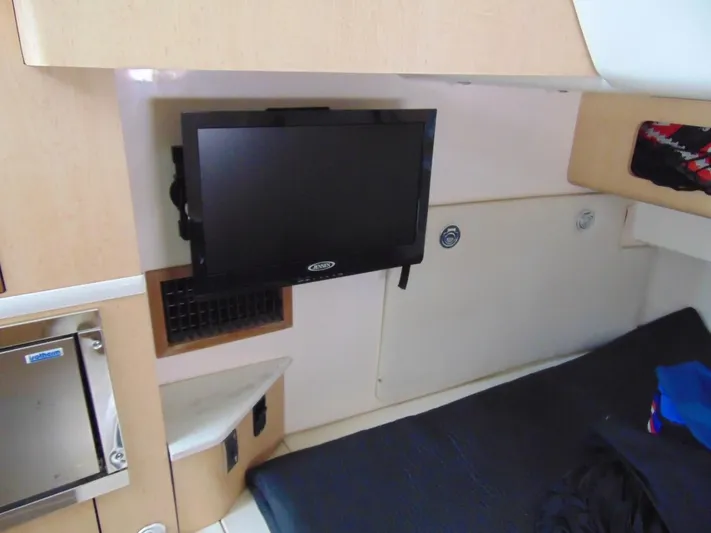 Reel Time Yacht Photos Pics Interior cabin of 2013 Boston Whaler 370 Outrage with mounted TV and bed.