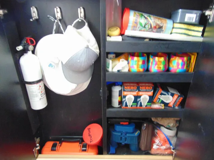 Reel Time Yacht Photos Pics Storage cabinet on 2013 Boston Whaler 370 Outrage with safety gear and supplies.