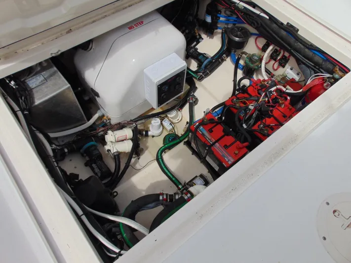 Reel Time Yacht Photos Pics Engine compartment of 2013 Boston Whaler 370 Outrage, showcasing mechanical components and wiring.