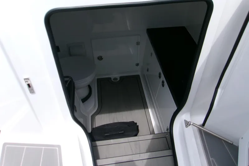  Yacht Photos Pics Interior view of 2026 Monterey Elite 30 OB boat cabin with toilet and storage.