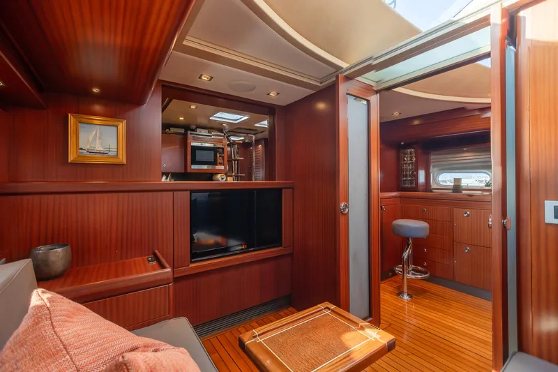 Assai Yacht Photos Pics Luxurious interior of 2011 Alia Yachts Warwick 82 LK with wooden finishes and modern amenities.
