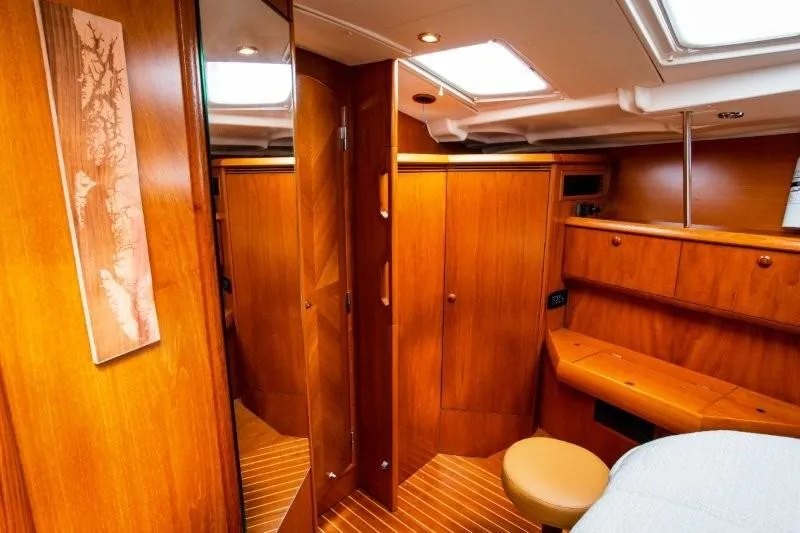 Rum Runner Yacht Photos Pics Interior of 2007 Jeanneau Sun Odyssey 54 DS yacht with wooden cabinetry and seating.
