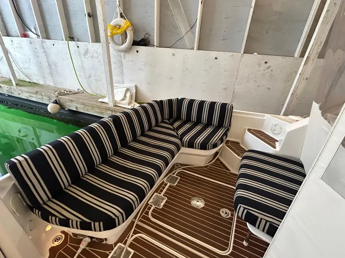  Yacht Photos Pics 2015 Back Cove 34 boat interior with striped seating and wooden flooring.