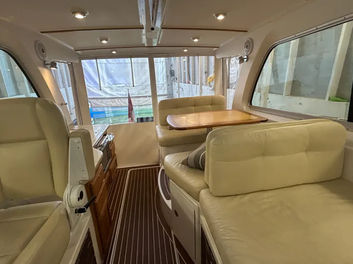  Yacht Photos Pics Interior of 2015 Back Cove 34 boat with beige seating and wooden table.
