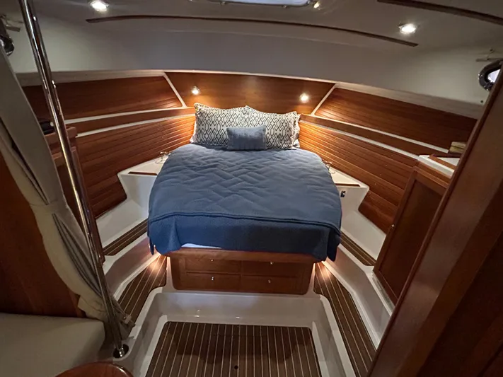  Yacht Photos Pics Luxurious cabin interior of 2015 Back Cove 34 boat with cozy bed and wooden accents.