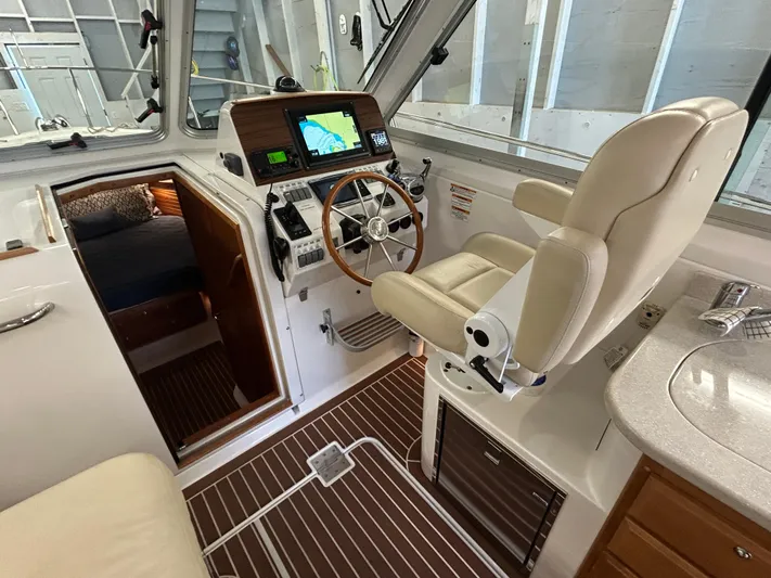  Yacht Photos Pics Interior of 2015 Back Cove 34 boat with helm, navigation system, and seating.