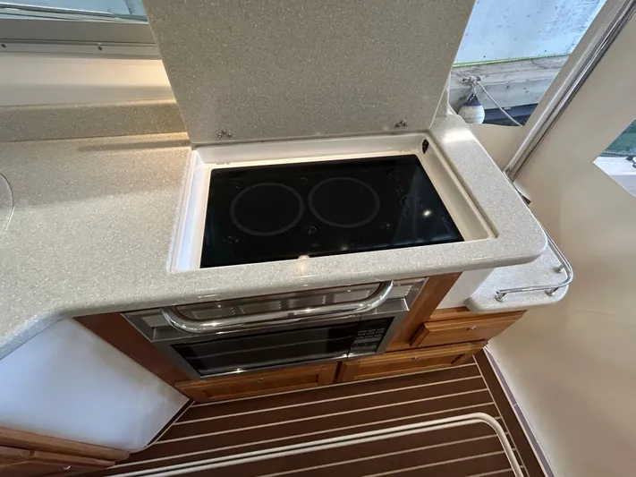  Yacht Photos Pics Modern kitchen area in a 2015 Back Cove 34 boat with stovetop and microwave.