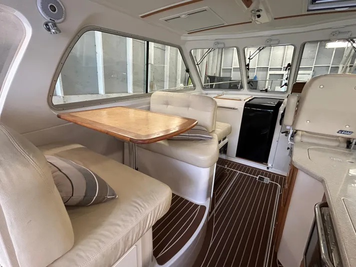  Yacht Photos Pics Interior of 2015 Back Cove 34 boat with seating, table, and wood flooring.
